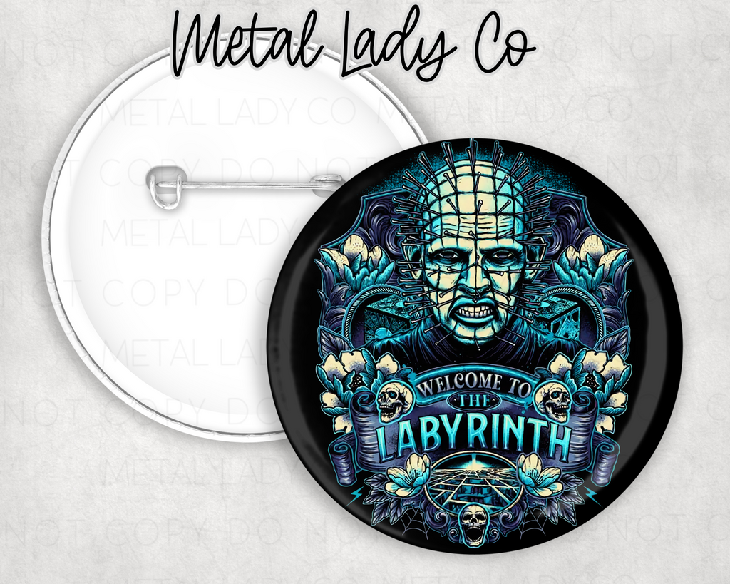 A round pinback button with an illustration of a character resembling Pinhead from a horror genre, with a stylized background and text that reads 'METAL LADY CO' and 'THE LABYRINTH'.