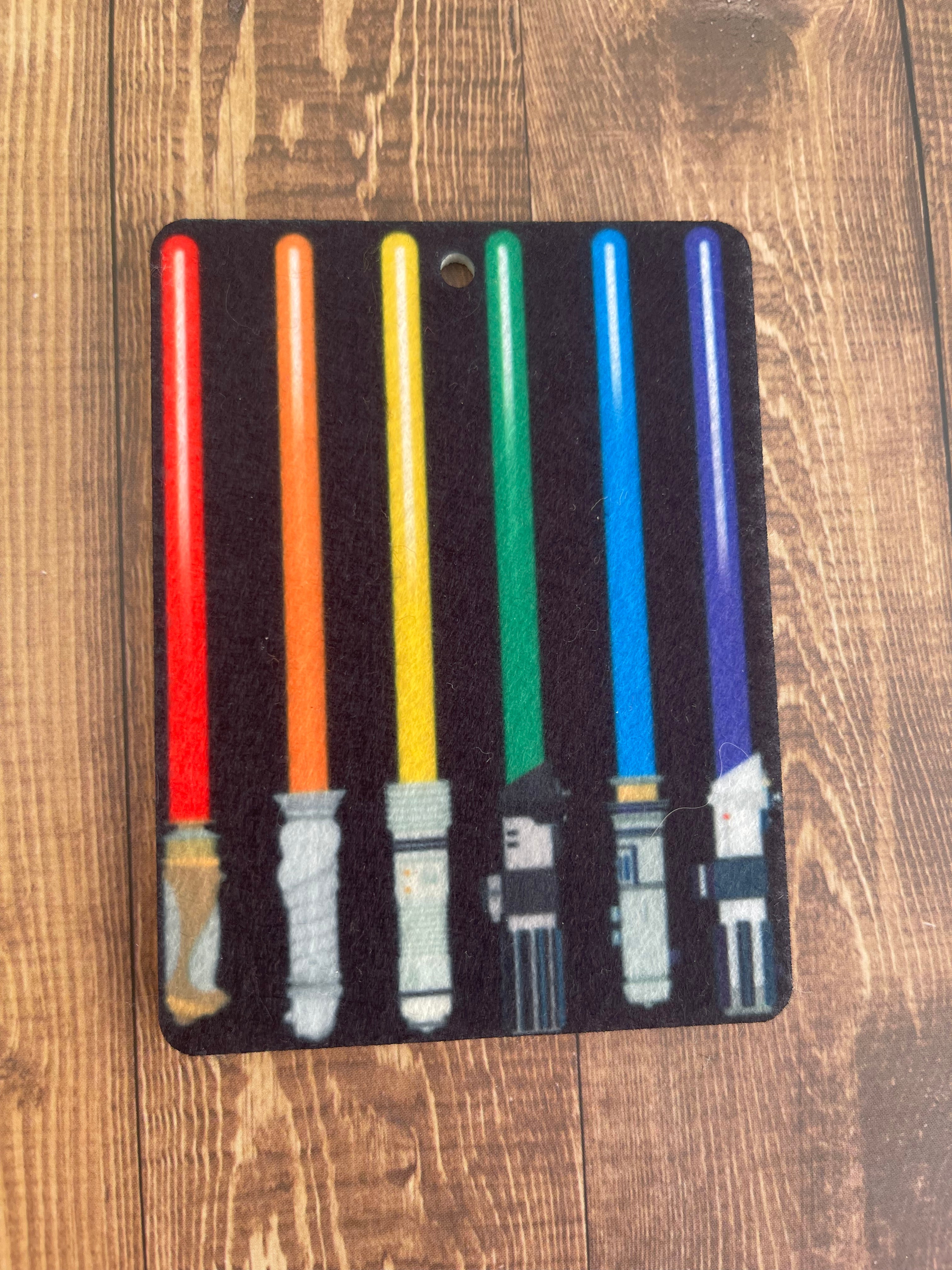 Light saber design on a black background with colored lightsabers.