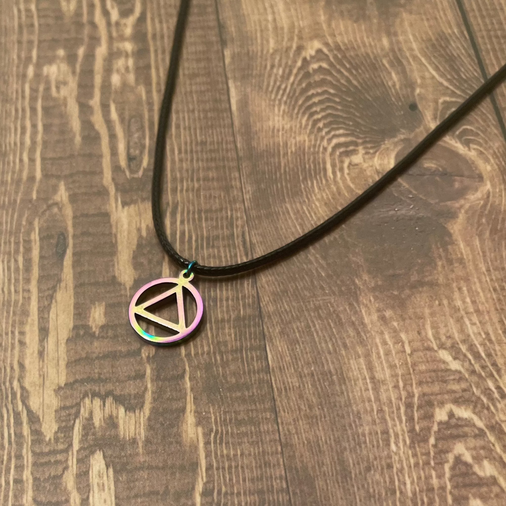 Necklace with a circular pendant on a wooden surface